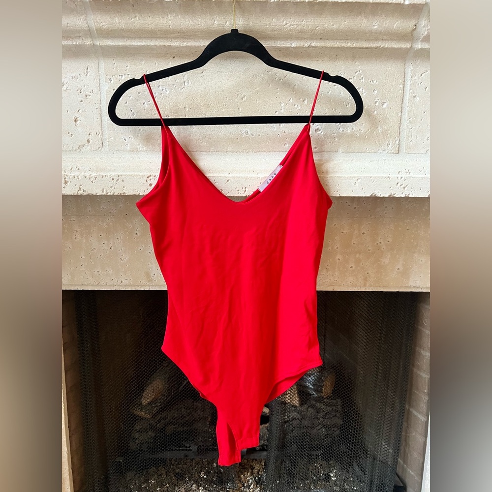 Red soft, double lined bodysuit, never worn